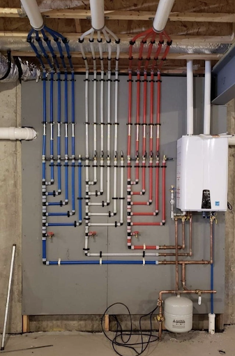 Clean PEX manifold and tankless water heater installation by Pro-On Plumbing